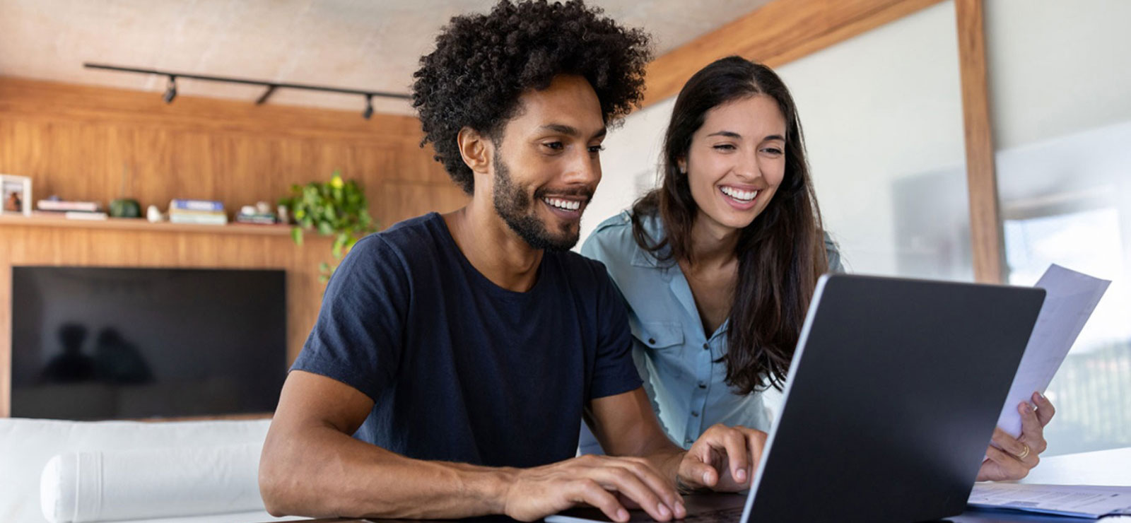 a couple looking at their laptop computer